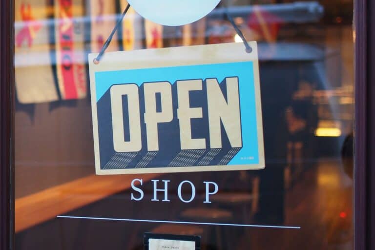 A shop with a good reputation displays an open sign in its window.