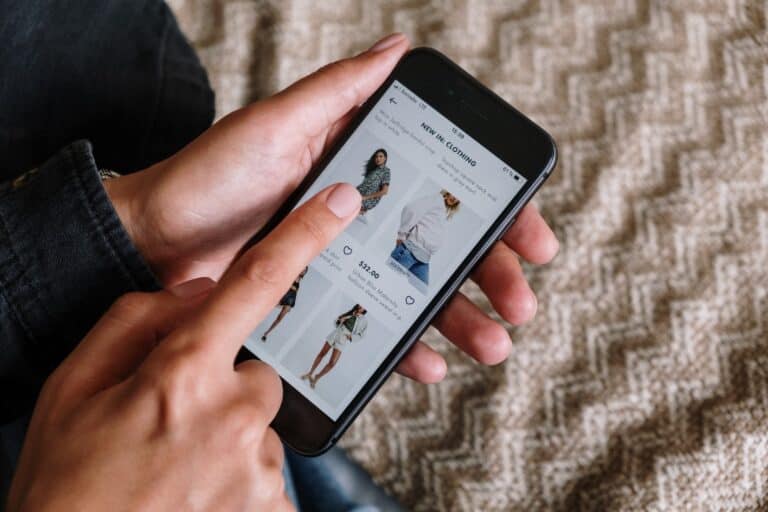 A person using an affiliate marketing clothing app on their smartphone.
