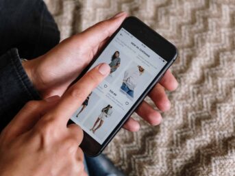 A person using an affiliate marketing clothing app on their smartphone.